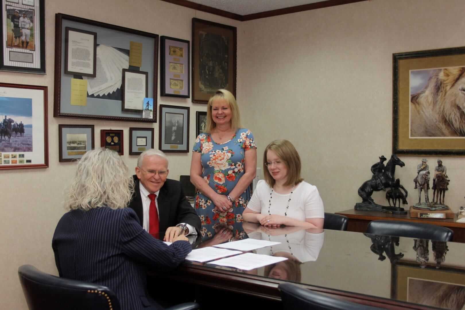 Photo of attorney Walter D. White and his legal team with clients